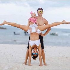 a man and woman on the beach doing acrobatic tricks with their child