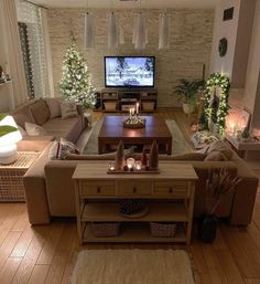 a living room filled with furniture and a flat screen tv sitting on top of a wooden table