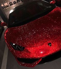 a red sports car covered in shiny glitter