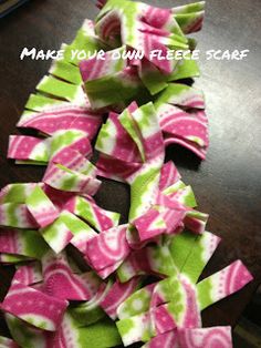 a pile of pink and green fabric scraps sitting on top of a wooden table