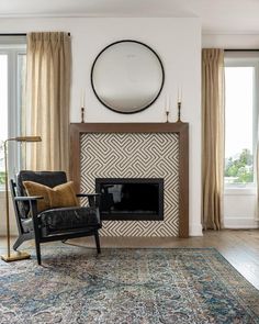 a living room filled with furniture and a fire place in front of a large window