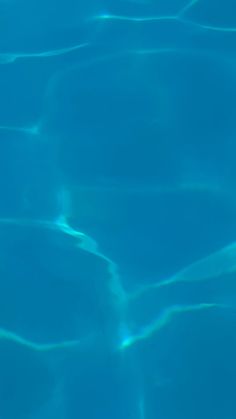 an empty swimming pool with clear blue water