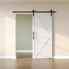 an empty room with a sliding barn door