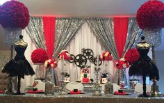 a table topped with lots of red and black decorations