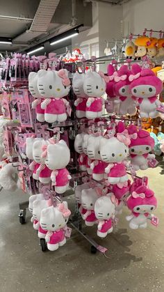 many hello kitty stuffed animals are on display