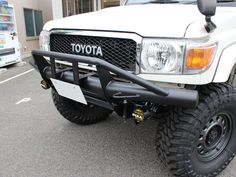 the front end of a white toyota truck