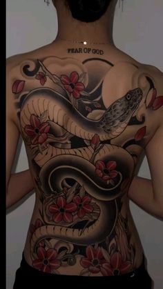 the back of a woman's body with tattoos on it