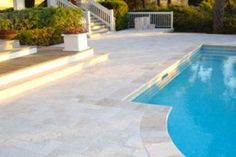 an empty swimming pool with steps leading up to it