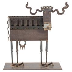 a metal sculpture of a machine with two legs