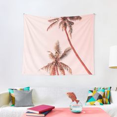 a pink wall hanging over a white couch