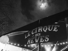 the sign for le cirque des reves is lit up in black and white