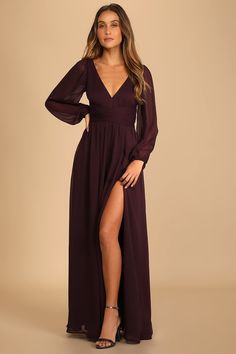 a woman in a long purple dress with a slit down the side and her legs crossed