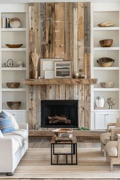 a living room filled with furniture and a fire place in front of a wooden wall