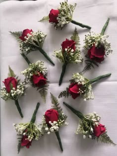 red roses and white baby's breath are arranged in a circle