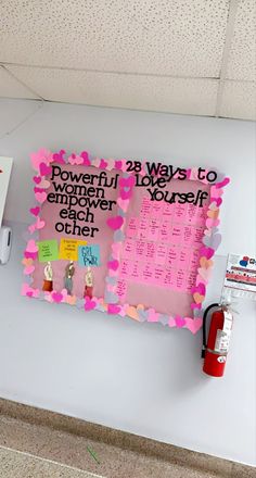 a bulletin board with pink hearts on it