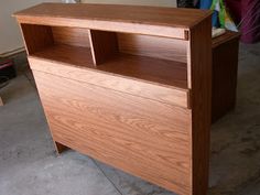 a wooden cabinet sitting on top of a cement floor