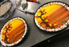 two cakes decorated to look like trees with leaves on them