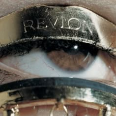 an eye with the word revlon written on it's iris and under its lid