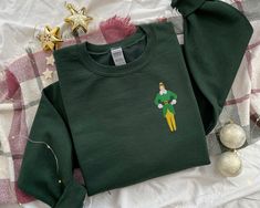 Elf Buddy, Elf Sweatshirt, Movie Tattoo, Elf T Shirt, Elf Movie, Christmas Crewneck, Buddy The Elf, Jolly Christmas, Embroidered Crewneck