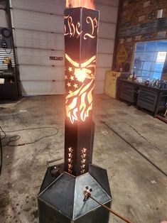 a large metal object with flames coming out of it's sides in a garage