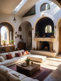 a living room filled with furniture and a fire place in the middle of an archway