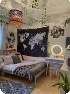 a bedroom with a bed, desk and hanging world map tapestry on the wall above it