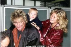 an older man and two young children are smiling