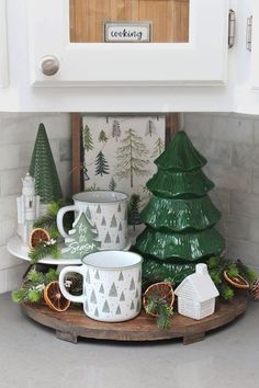 a kitchen counter with christmas decorations and coffee mugs