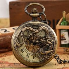 Description: Personalized Appearance: The pocket watch case is exquisitely with a dragon pattern, which is very charming and cool. Durable Movement: This is a hand-winding mechanical watch can keep work by daily manual movement without the batteries are required. Adjust Time: Just pull out the crown on the top of the case and then rotate it clockwise gently until reach the time you want. Beautiful Ornament: It is more than a pendant watch that you can even wear it as a exquisite decoration. Bett Steampunk Dragon, Steampunk Pocket Watch, Bronze Dragon, Mechanical Pocket Watch, Pocket Watch Antique, Fob Watch, Clock Gift, Pendant Watches, Antique Pendant