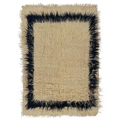 a black and white rug with fringes on it