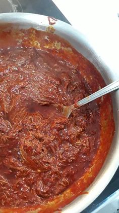 a large pot filled with sauce on top of a stove