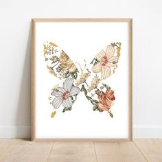 an art print of a butterfly with flowers on it's wings, in front of a white wall