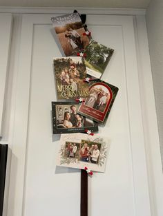 a white door with christmas cards hanging from it's side and pictures on the front