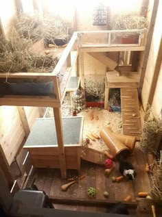 an overhead view of a chicken coop with hay and other things in the area around it