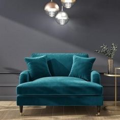 a living room with a blue couch and two lamps