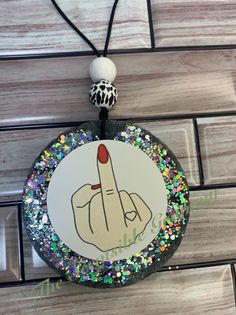 a rock and roll necklace with glitters on it