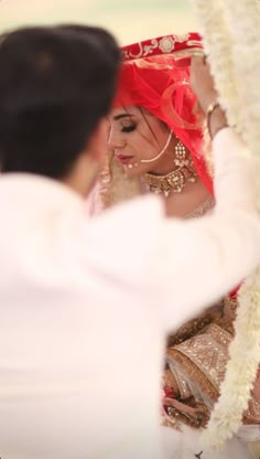 the bride and groom are looking at each other