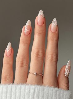 Are you looking for fun and festive nail art to get you in the winter spirit? You'll love this roundup of 40 magical snowflake nail designs! From minimalistic snowflake art to full-on winter wonderlands on your fingers, there's something for every snowflake lover. Click for cozy grey snowflakes, emerald forest snowflakes and so much more! With options this cute and creative, you'll be dying to try them all. Pin your faves for future #manicuremonday inspo. Snowflake Nails Acrylic Almond, White Nail Christmas Designs, Christmas Nails Almond Snowflake, Christmas Nails Inspo Almond, Winter Engagement Nails Ideas, Winter Nails After Christmas, Winter Nails Nude Color, Christmas Nails Almond White, Christmas Bridal Nails