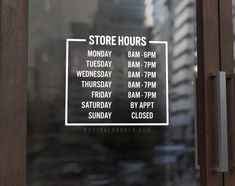 a store hours sign in the window of a building