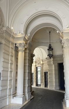 an archway leading to two doors and a light hanging from the ceiling in front of it