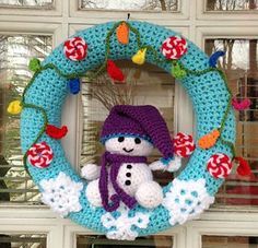 a crocheted wreath with a snowman on it