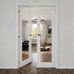 an open door leading to a living room with wood flooring and white walls in the background