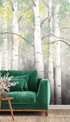 a green couch sitting in front of a wall with trees on it and the words whimsical woodlandss