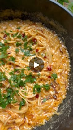 a skillet filled with pasta and garnished with parsley