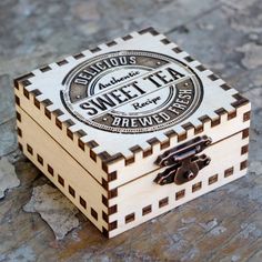 a small wooden box sitting on top of a stone floor next to a piece of wood