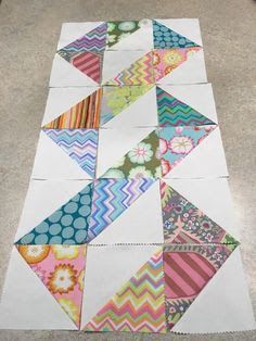 four different colored pieces of paper laid out on the floor