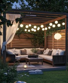 an outdoor living area with couches and lights