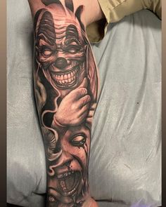 a man with a tattoo on his arm has a creepy clown face and two hands