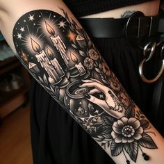 a woman with a black and white tattoo on her arm holding a candle in the shape of a heart