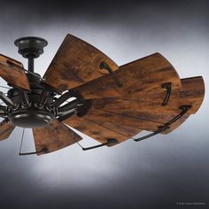 a ceiling fan made out of wood and metal